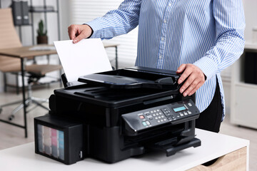 Wall Mural - Woman using modern printer at workplace indoors, closeup