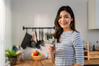 © Kawee - Portrait of Asian young woman drink a glass of water in kitchen at home.