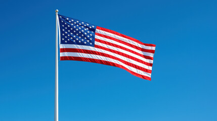 American flag waving on a clear blue sky background, symbolizing patriotism and freedom in the USA.