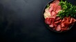 © Paul - Charcuterie board from above, a mix of cured meats and cheeses with sprigs of herbs, set on a black surface, high-contrast lighting, plenty of negative space.