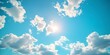 © Thanthara - Beauty of summer sky with scattering of fluffy white clouds against backdrop of bright blue. Scene exudes tranquility and making ideal for aim to evoke calm and peaceful atmosphere