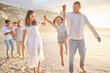 © peopleimages.com - Beach, family and parents swing child on vacation, adventure or getaway together for bonding by sea. Happy, generations and children with grandparents and mom and dad for fun by ocean on holiday.