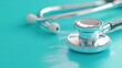 © Vee - Close-up of a shiny stethoscope on a teal surface, symbolizing healthcare, medical examinations, and patient care.