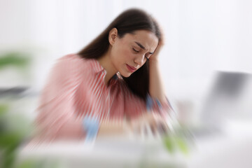 Sticker - Woman suffering from headache indoors, motion blur effect