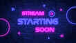 © AIDIN - live stream starting soon neon lights text on dark blue brick wall, streaming and broadcasting social media design element