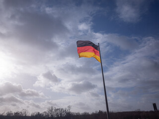 a german national flag flattering in the air on the historical building of national diet in berlin