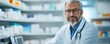 © thanawat - A professional pharmacist in a white coat smiles while standing in a well-stocked pharmacy, representing healthcare and trust.