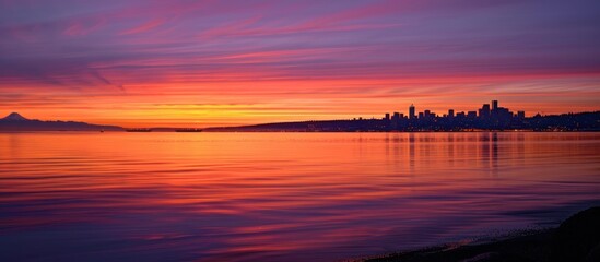 Wall Mural - Colorful Seattle Sunrise Across Elliott Bay. Seen from West Seattle this modern city sparkles just before the sun rises above