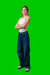 © fotofabrika - Young Woman Standing With Arms Crossed in Front of Green Screen