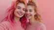 © Андрей Гурков - Two young women with pink and blonde hair smiling together against a pink background during daylight