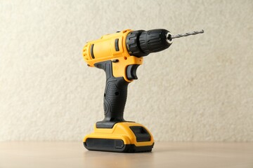 Wall Mural - One cordless electric drill on wooden surface