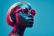 © valentyn640 - A woman wearing pink sunglasses against a blue background.