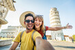 © Davide Angelini - Happy tourist couple taking selfie picture in front of the famous leaning Tower and Pisa cathedral - Summertime holidays, tourism and technology concept -