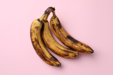 Sticker - Bunch of ripe bananas with dark spots on pink background, top view