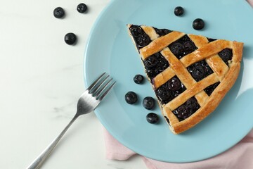 Wall Mural - Piece of tasty homemade pie with blueberries served on white marble table, flat lay