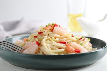 Wall Mural - Delicious pasta with shrimps, green onion and chili pepper on white table, closeup