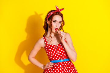 Photo of cute sweet pretty lady wear red stylish summer clothes eat candy isolated on yellow color background