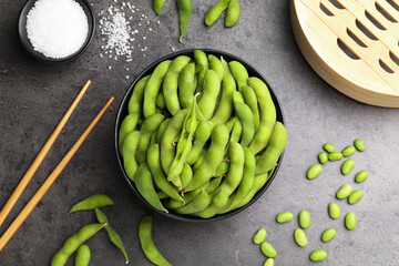 Wall Mural - Raw green edamame soybeans and pods on grey table, flat lay