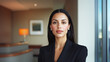 © Luluraschi - portrait of a confident young hispanic woman in black formal suit, professional receptionist