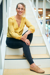 Poster - Portrait, smile and business woman at stairs at creative startup for job opportunity in Sweden. Young, happy and worker at office, entrepreneur or journalist on steps for future company growth