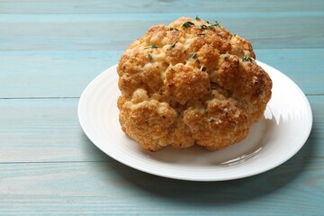 Wall Mural - Delicious baked cauliflower on light blue wooden table