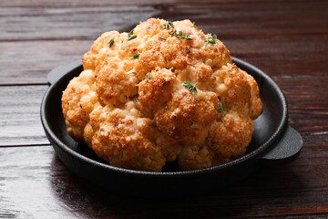 Canvas Print - Delicious baked cauliflower in baking dish on wooden table, closeup