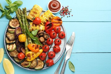 Poster - Delicious grilled vegetables served on light blue wooden table, flat lay