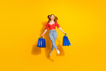 Canvas Print - Full size photo of pretty young girl hold shopping bags jumping excited wear trendy red retro outfit isolated on yellow color background