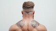 © fotogurmespb - Top-down view of a warrior haircut with a short, spiked crest running down the middle, shaved sides with intricate carvings, white background