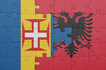 puzzle with the colourful national flag of albania and flag of madeira.