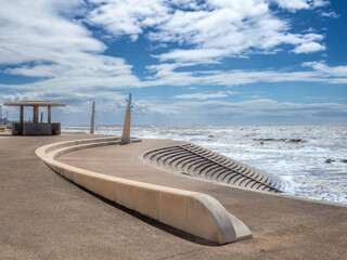 Seafront at Thornton Cleveleys showing the modern curved sea defenses with steps and concrete shelter