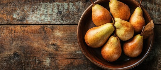 Poster - Plate with fresh pears on a wooden table. with copy space image. Place for adding text or design