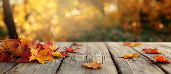 Wall Mural - autumn leaves on the wooden table blurred effect. with copy space image. Place for adding text or design