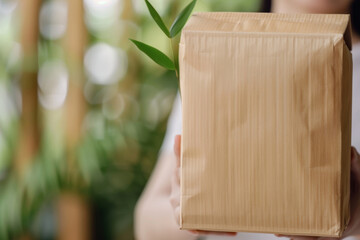 Wall Mural - Eco-friendly bamboo paper package being opened to reveal a sustainable product inside. Green packaging and eco-conscious shipping solutions. Sustainability in modern commerce. Sustainable packaging.