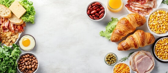 Fototapete - Breakfast is served in the morning on the table with croissant bread croissant cereal bacon ham cheese lettuce beans corn flakes and fruits for a healthy meal Top view with copy space