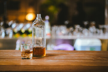 Whiskey drinks at the bar celebrating a special event in a luxury bar. Close-up shows a cheerful atmosphere as glasses clink together, reflecting a lively and joyful gathering.