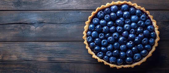 Leinwandbilder - Blueberry tart on a wooden surface top view copy space