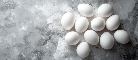 Leinwandbilder - Fresh white eggs on a gray background Top view A rural still life featuring natural organic healthy food with available space. with copy space image. Place for adding text or design