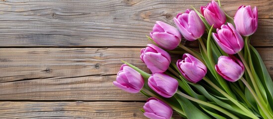 Fototapete - Spring Flowers holiday background Gift ideas for Easter or Mother s Day Purple tulips on a wooden table Copy space top view area for text