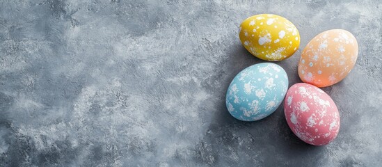 Poster - Arrangement of Easter painted eggs on a gray stone textured background Copy space Top view