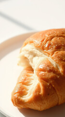 Canvas Print - Close-up of a Freshly Baked Croissant on a White Plate