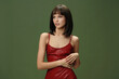 © SHOTPRIME STUDIO - Woman in red dress with hands on hips, posing confidently against a vibrant green background, creating a striking contrast between her outfit and the backdrop, embodying elegance and boldness