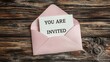 © Sippung - You are invited : Rustic white invitation card in pastel pink envelope on wooden background for country style event