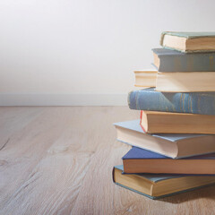 Stack of Vintage Antique Books Stacked in a Pile on a Wooden Floor