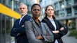 © ORG - Three businessmen, man and woman focus on camera with arms crossed, portrait of coworkers outside office building
