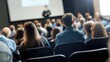 © Anton Gvozdikov - Diverse audience attentively listening to speaker at business presentation in modern conference hall with focus on engagement and learning.