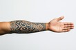 © Kaleb - Arm with tribal tattoo on white background