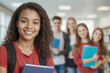 © polack - Portrait of student girl in the red shirt holding book and looking at the camera. A group of young people students are smiling and holding books