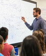 © Marco Attano - Teacher explaining mathematical concepts on a large interactive whiteboard, advanced calculus equations, attentive high school students