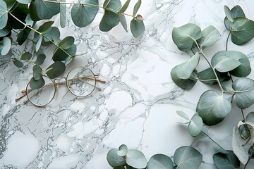 Wall Mural - Elegant Arrangement of Eucalyptus Leaves and Stylish Glasses on Marble Surface